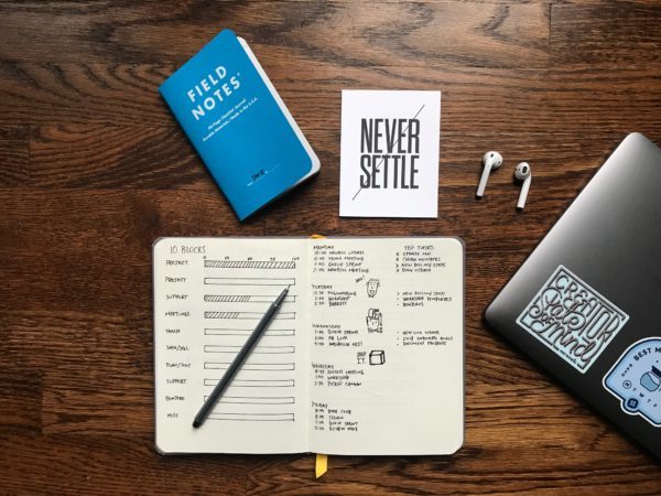 a notebook with someone setting goals