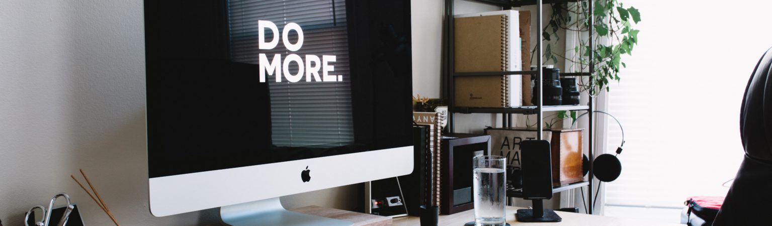 computer with screen saver that says "do more" as a reminder to be more productive