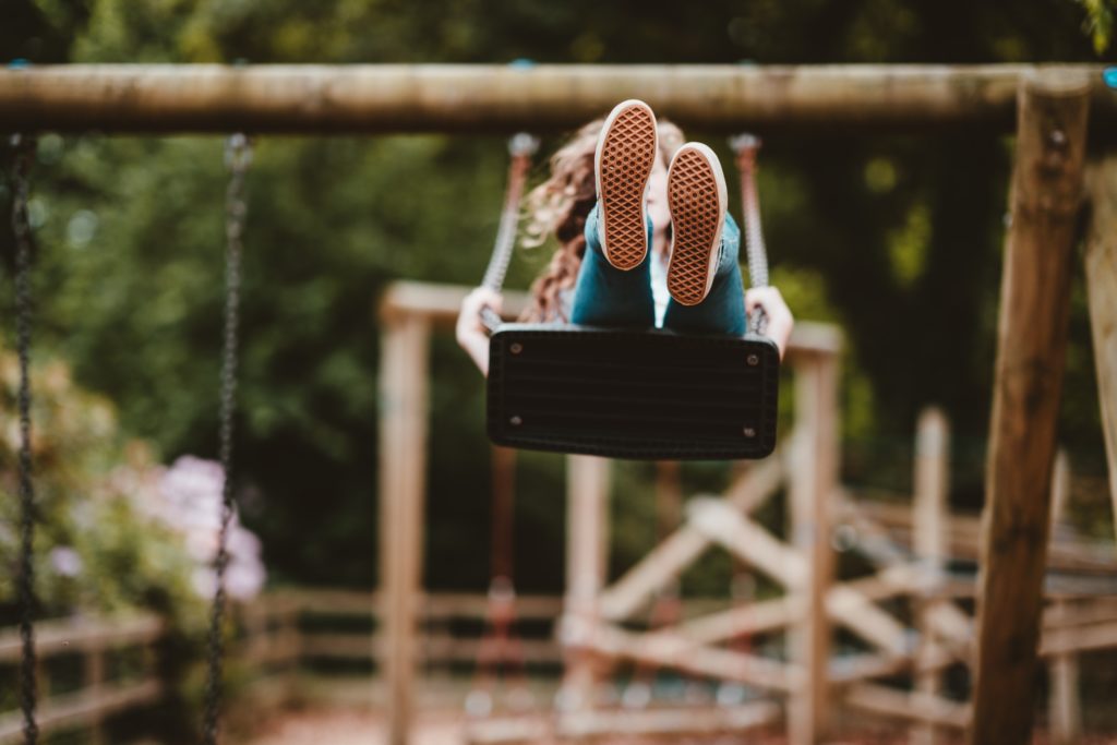 why play matters, a child swinging 