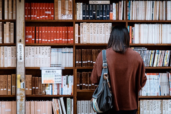 A woman looking at books in a library