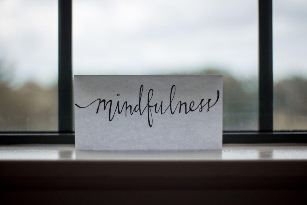 Mindfulness' written on a paper near the window
