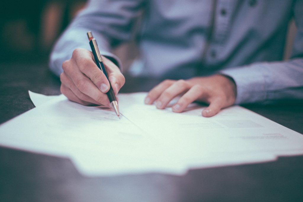 A person signing few paperwork
