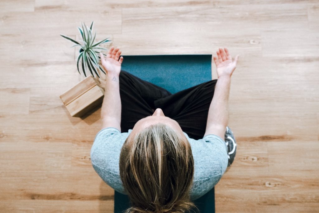 A woman doing yoga on a yoga mat