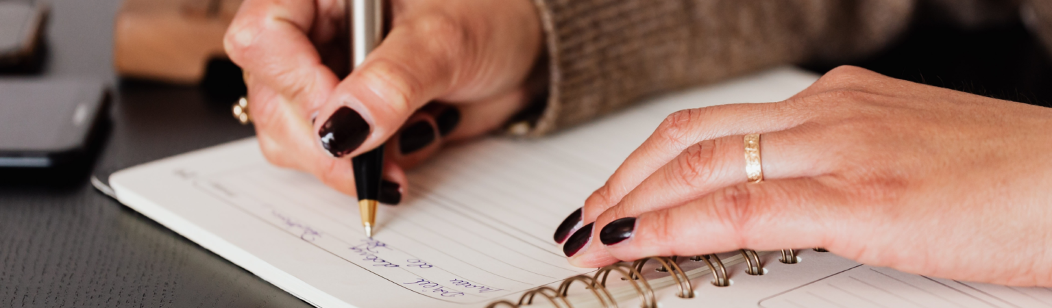 woman writing in a notebook