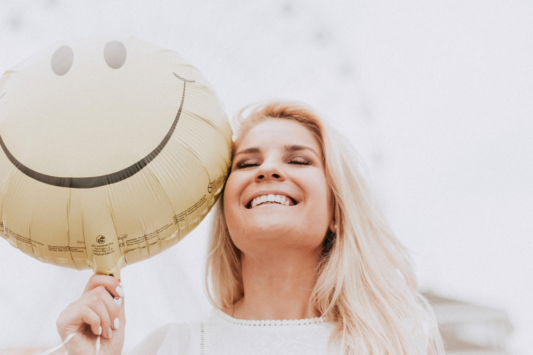 woman smiling with balloon
