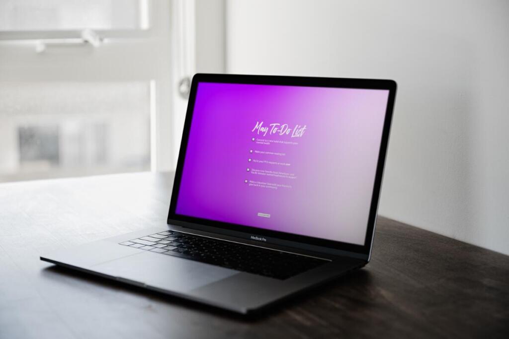 Laptop with purple gradient May to-do list tech background