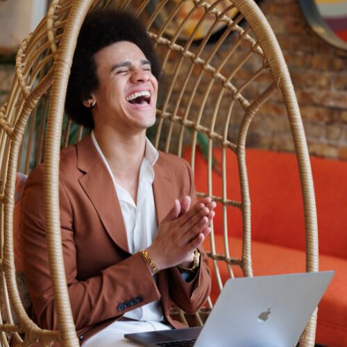 relationship strategist, Justice, laughing at his computer