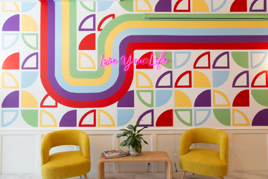 Love Your Life with Ama La Vida - neon sign on trendy office wall in the Happiness Hub in our Chicago office