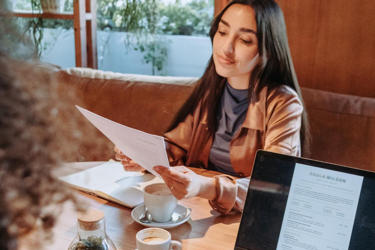woman with papers at coffee shop