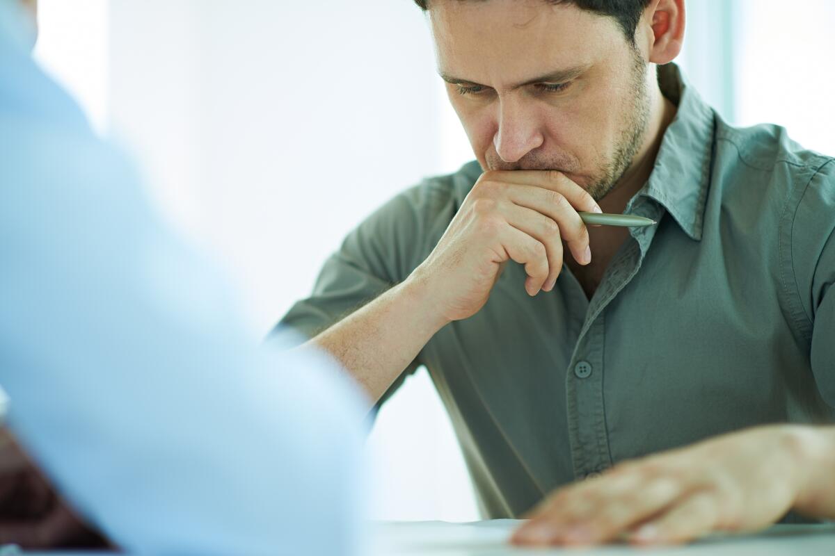 Man looking at papers with concern