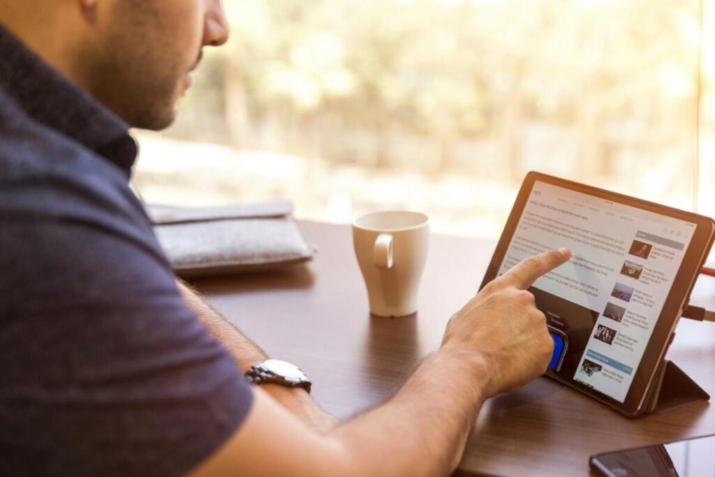 Man looking at website on tablet