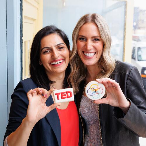 ama la vida co-founders foram and nicole holding cookies with the Ted logo and Ama La Vida logo