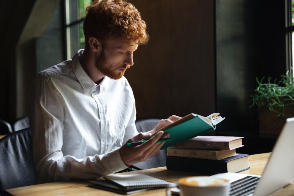 Man reading books and taking notes