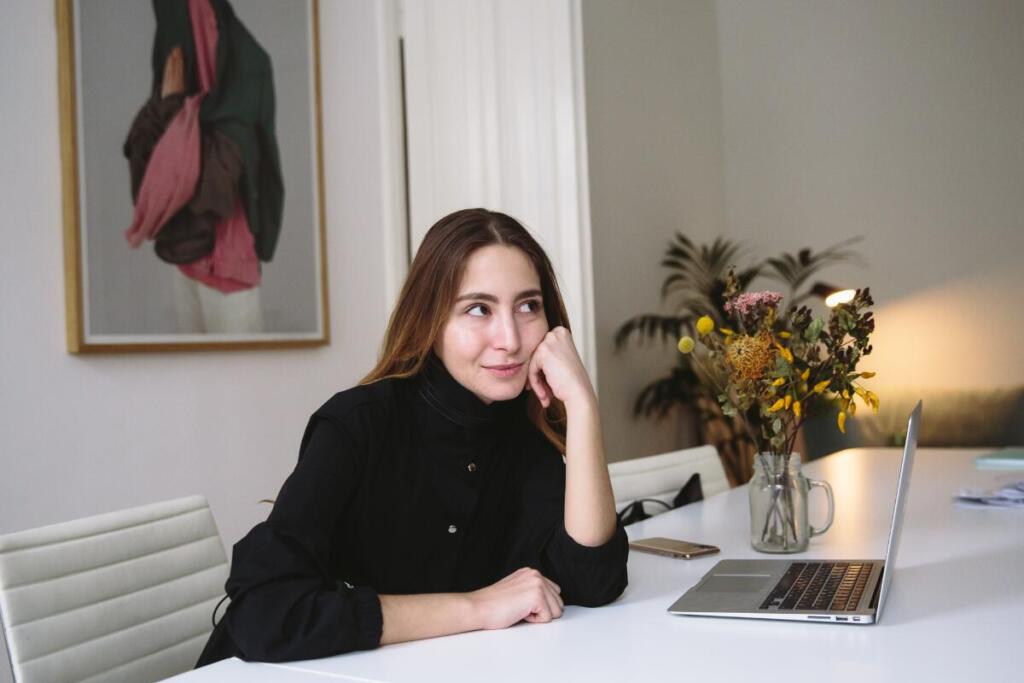 Woman sitting at desk thinking