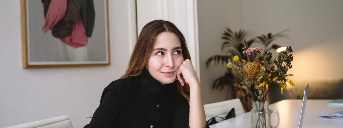 Woman sitting at desk thinking