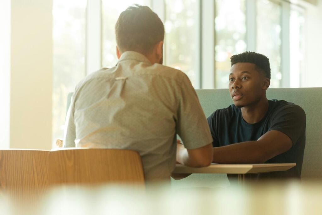 Two men meeting at table