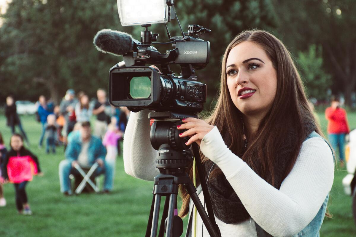 Woman behind video camera