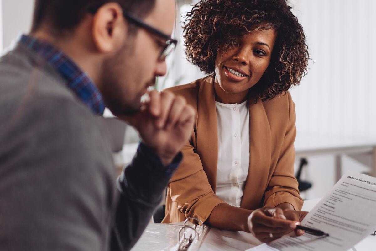 Woman showing man notes/contract