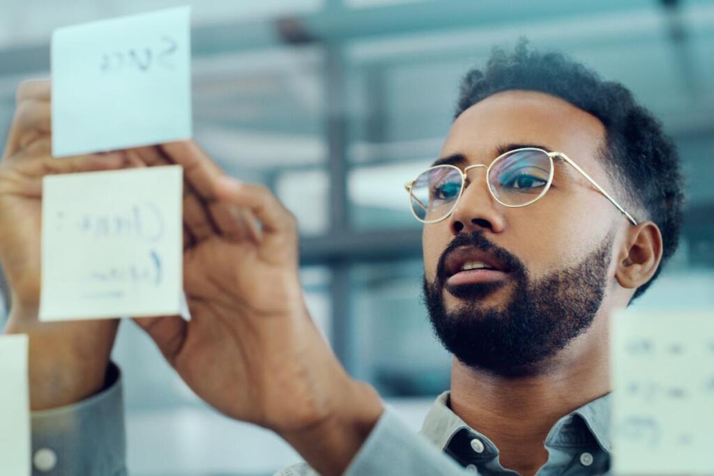 Man writing on post its