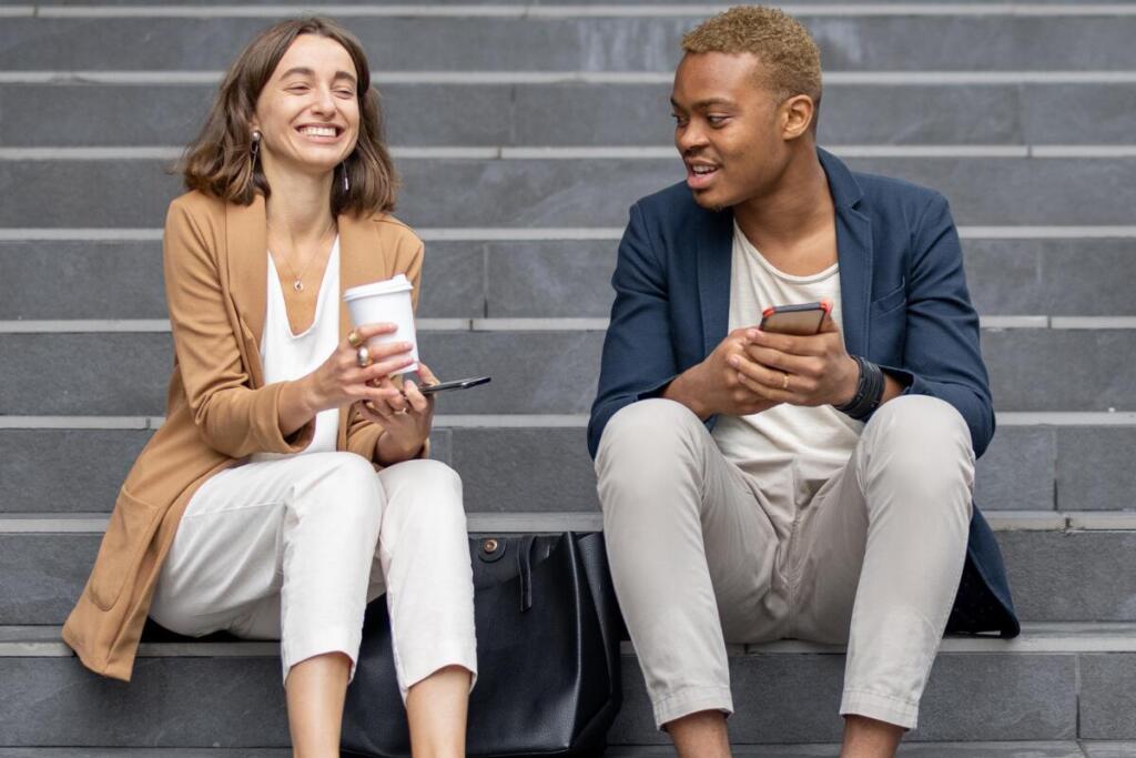 two people talking while sitting on steps