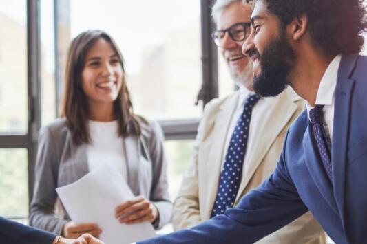 two professionals meeting and shaking hands. approach your networking strategy better by growing quality connections.