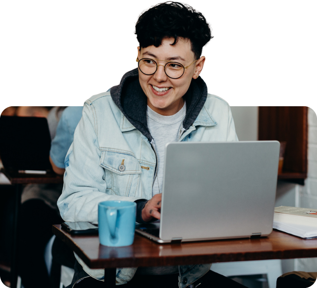 cool person with a laptop and coffee working from a cafe