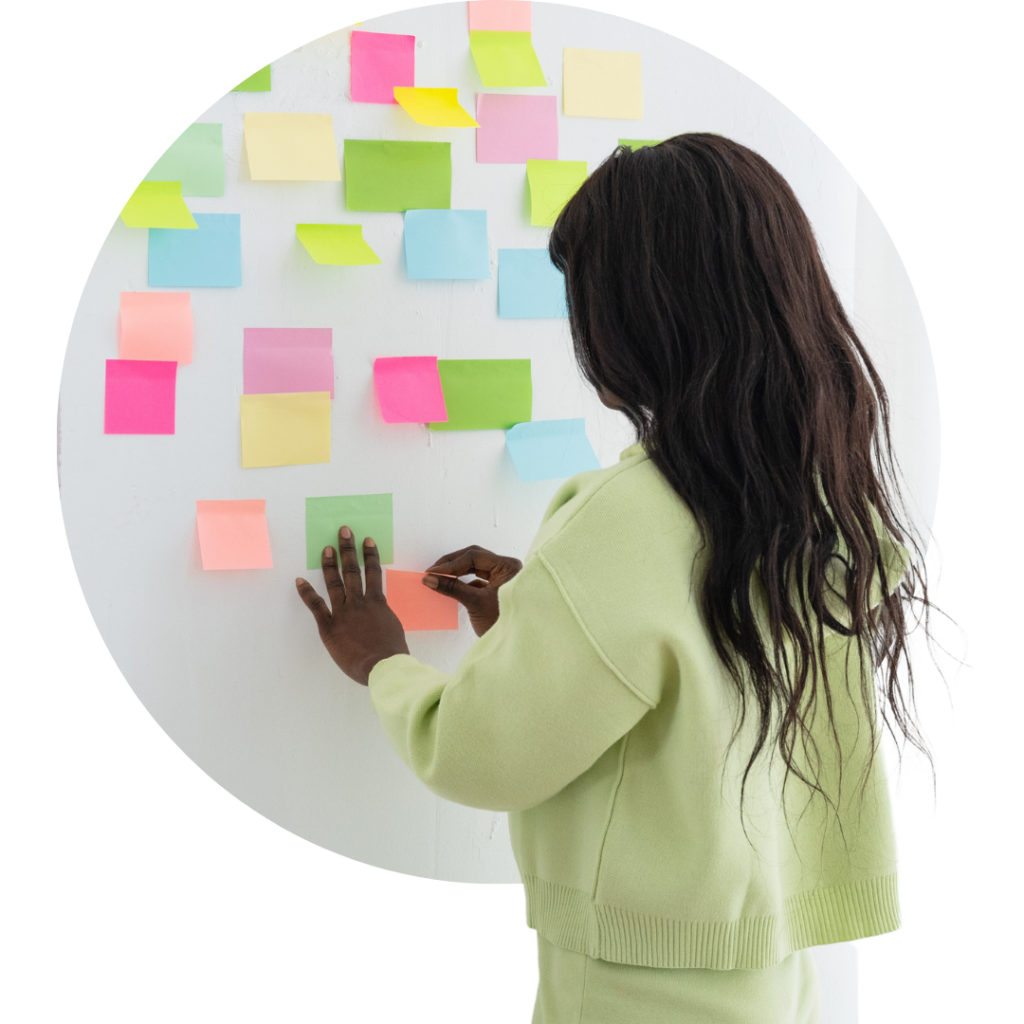 creative woman mapping a work project with sticky notes on a wall