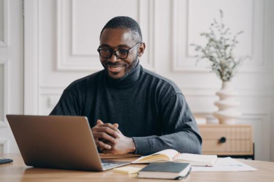 man on conference call on laptop