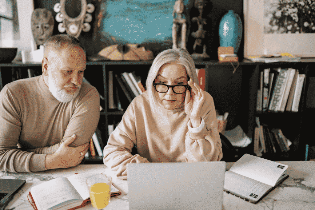 A mature couple sitting to plan their transition to retirement together as a shared vision.