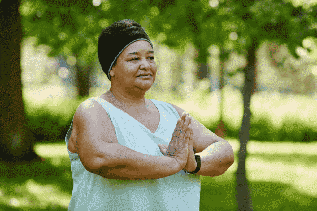 Mature woman in park doing yoga.